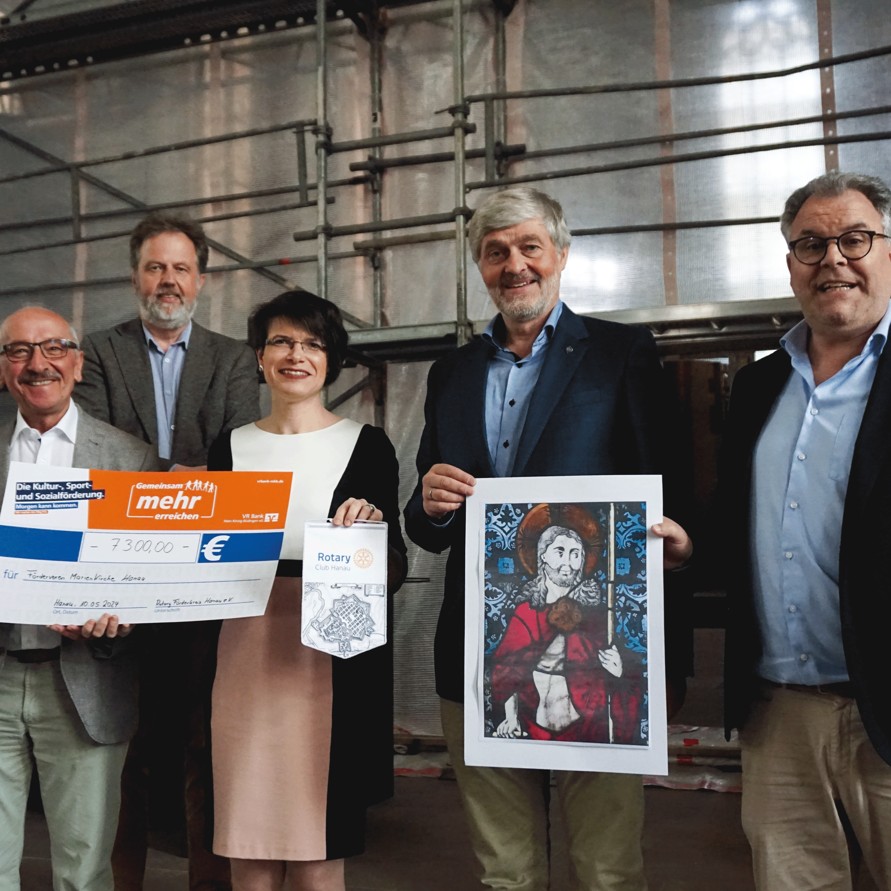 Gruppenbild mit Spendenscheck und einem Bild der Glasmalerei mit Förderkreisvorsitzendem, Dekan, geschäftsführerender Pfarrerin und 2 Vertretern des Rotary Club Hanau